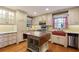 Bright kitchen featuring light cabinets, stainless appliances, granite counters, and hardwood floors at 59 Oakmont Nw Dr, Marietta, GA 30064