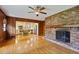Living Room with hardwood floors, brick fireplace, and view into the adjacent updated kitchen at 59 Oakmont Nw Dr, Marietta, GA 30064