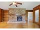 Living room features wood paneling, brick fireplace, built-in bookcase, hardwood floor, and ceiling fan at 59 Oakmont Nw Dr, Marietta, GA 30064