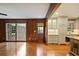 Living room features hardwood floors, wood paneling, and an adjacent updated kitchen at 59 Oakmont Nw Dr, Marietta, GA 30064