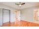 Bright bedroom with tray ceiling, ceiling fan, and wood floors leads to a bathroom at 8 Southview Dr, Cartersville, GA 30121