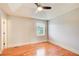 Bedroom features hardwood floors, a tray ceiling, ceiling fan and a large window at 8 Southview Dr, Cartersville, GA 30121