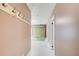 Hallway with light pink walls, white tile flooring, and backdrop in the background at 8 Southview Dr, Cartersville, GA 30121