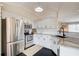Modern kitchen with stainless steel appliances, white cabinets and black hexagon tile floor at 8 Southview Dr, Cartersville, GA 30121