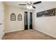 This bedroom features neutral walls, carpet floors, ceiling fan, and two wall decorations at 1714 Indian Way, Cumming, GA 30040