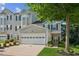 Attractive townhome featuring a two-car garage, classic siding, and landscaped front yard at 1714 Indian Way, Cumming, GA 30040