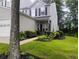 Charming two-story townhome with well-manicured lawn, lovely landscaping, and attached garage at 1714 Indian Way, Cumming, GA 30040