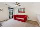 This loft has carpet, a window, a ceiling fan, and a red futon in the corner at 1714 Indian Way, Cumming, GA 30040