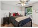 The main bedroom has gray walls, a ceiling fan, a black bed frame with a decorative headboard at 1714 Indian Way, Cumming, GA 30040