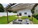 Backyard featuring a pergola with seating, patio, white fence, and well-kept lawn at 400 Silver Spring St, Dallas, GA 30157