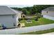 Large backyard with a white fence, covered seating area, grill, and trampoline at 400 Silver Spring St, Dallas, GA 30157