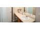 Well-lit bathroom with a white countertop sink and wooden cabinet at 400 Silver Spring St, Dallas, GA 30157