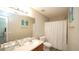 Bright bathroom with modern fixtures, vanity, and shower with curtain at 400 Silver Spring St, Dallas, GA 30157