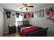 A bedroom with a ceiling fan, a window, and sports jerseys on the wall at 400 Silver Spring St, Dallas, GA 30157