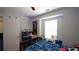 Cozy bedroom with a ceiling fan, window, and a well decorated wall at 400 Silver Spring St, Dallas, GA 30157