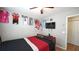 A bedroom with a ceiling fan, a window, and sports jerseys on the wall at 400 Silver Spring St, Dallas, GA 30157