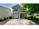 Two story home featuring attached garage, blue shutters, and a well maintained lawn at 400 Silver Spring St, Dallas, GA 30157