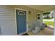 Inviting front entrance with a blue door, decorative window, and charming wicker seating at 400 Silver Spring St, Dallas, GA 30157