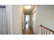 Well-lit hallway with wood floors, fresh paint, and access to several rooms, creating a seamless flow at 400 Silver Spring St, Dallas, GA 30157