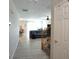 Hallway leading to living room with ceiling fan and staircase with carpet at 400 Silver Spring St, Dallas, GA 30157