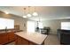 Bright kitchen with stainless sink, wood cabinets, and spacious island with modern pendant lighting at 400 Silver Spring St, Dallas, GA 30157