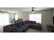 Comfortable living room with gray sectional sofa, ceiling fan, and tile floors at 400 Silver Spring St, Dallas, GA 30157
