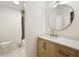 Modern bathroom with stylish vanity, round mirror, and tiled shower with rainfall showerhead at 4523 Doc Sams Rd, Cumming, GA 30028
