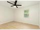 Bright bedroom with new light-colored wood flooring and a modern ceiling fan at 4523 Doc Sams Rd, Cumming, GA 30028