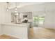 Modern kitchen with grey cabinets, quartz countertop, stainless steel appliances, and open to sun room at 4523 Doc Sams Rd, Cumming, GA 30028