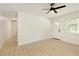 Spacious living room with plenty of natural light, new floors, and a view into the hallway at 4523 Doc Sams Rd, Cumming, GA 30028