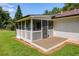 Exterior view of screened porch with wood deck and stairs down to the yard at 4523 Doc Sams Rd, Cumming, GA 30028