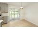 Bright sun room with access to the kitchen and sliding doors that lead to an outdoor deck at 4523 Doc Sams Rd, Cumming, GA 30028