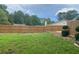Spacious backyard featuring a tall wood privacy fence, green grass and mature trees at 1150 Terramont Dr, Roswell, GA 30076