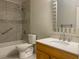Updated bathroom featuring a shower/tub combo, a white toilet, and a light wood vanity at 1150 Terramont Dr, Roswell, GA 30076