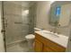 Bright bathroom features a walk-in shower with stone pebble flooring, white toilet, and light wood vanity at 1150 Terramont Dr, Roswell, GA 30076