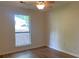 Bedroom with wood floors, a ceiling fan, and a large window overlooking the front yard at 1150 Terramont Dr, Roswell, GA 30076
