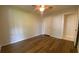 Cozy bedroom features wood floors, a ceiling fan, and a closet with an adjacent bathroom entry at 1150 Terramont Dr, Roswell, GA 30076