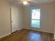 Bright bedroom featuring hardwood floors, a ceiling fan, closet and a window at 1150 Terramont Dr, Roswell, GA 30076