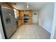Eat-in kitchen featuring stainless steel appliances, stone countertops and tile flooring at 1150 Terramont Dr, Roswell, GA 30076