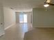 Open concept living room featuring tile and carpet flooring and sliding glass door access to patio at 1150 Terramont Dr, Roswell, GA 30076