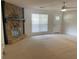 Bright living room with plush carpet, ceiling fan and a stone fireplace at 1150 Terramont Dr, Roswell, GA 30076