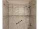 A tile shower with updated shower head and safety grab bar installed at 1150 Terramont Dr, Roswell, GA 30076