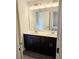 Elegant bathroom featuring a double sink vanity with dark wood cabinets and a large mirror at 145 Scarlett Place Dr, Bowdon, GA 30108