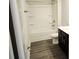 Well-lit bathroom featuring a shower-tub combo, a toilet, and a vanity with dark wood cabinets at 145 Scarlett Place Dr, Bowdon, GA 30108