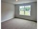 Bright bedroom with a large window and neutral carpet, offering a serene and comfortable space at 145 Scarlett Place Dr, Bowdon, GA 30108