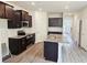Spacious kitchen featuring stainless steel appliances, granite countertops, and dark wooden cabinetry at 145 Scarlett Place Dr, Bowdon, GA 30108