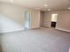 Spacious living room with neutral carpet, recessed lighting, and access to a bathroom through an open doorway at 145 Scarlett Place Dr, Bowdon, GA 30108