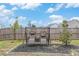 Relaxing backyard featuring a glider bench with comfortable seating, surrounded by landscaping and greenery at 36 Ivy Chase Loop, Dallas, GA 30157