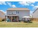 Spacious backyard with a covered patio, outdoor seating, and a well-maintained lawn, great for outdoor activities at 36 Ivy Chase Loop, Dallas, GA 30157
