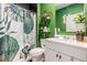 Vibrant bathroom with unique leaf-patterned shower curtain and stylish green walls, creating a distinctive look at 36 Ivy Chase Loop, Dallas, GA 30157